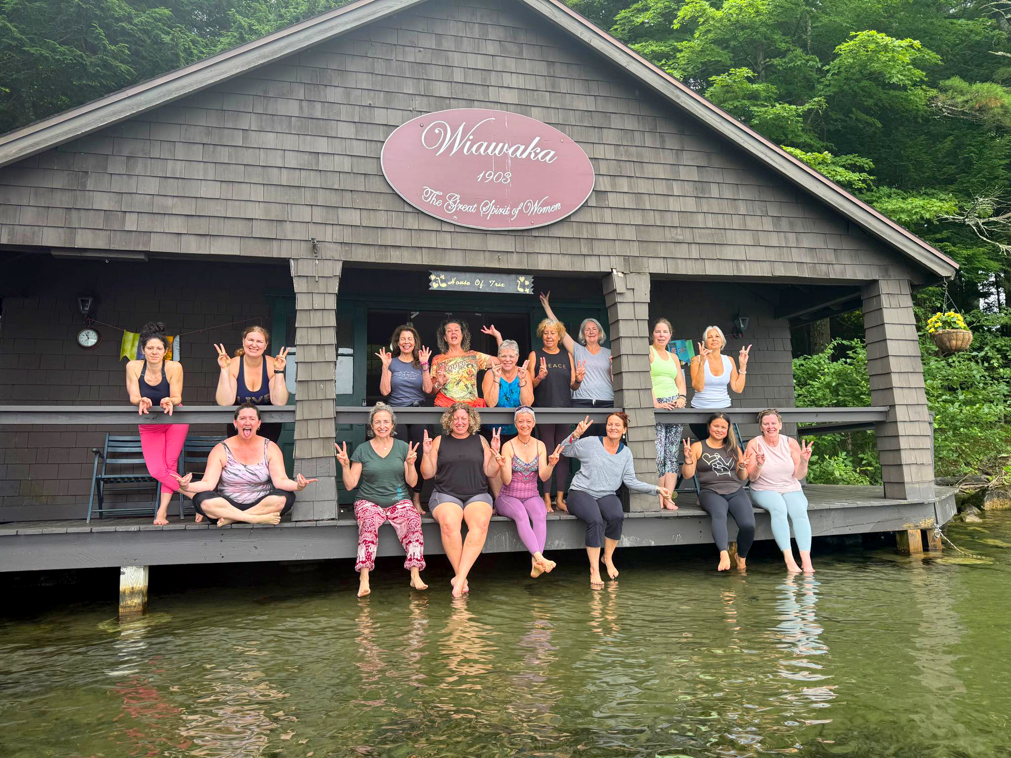 Waiwaka Retreat at Lake George – Yoga & Community Women’s yoga and wellness retreat group photo at Waiwaka on Lake George, NY with the lake and cabin